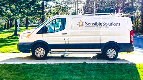 White Sensible Solutions work truck sitting the sun